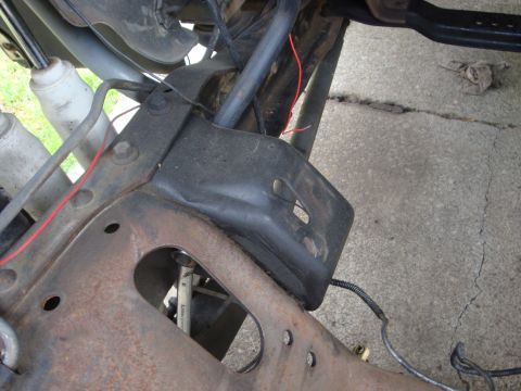 1989 Ford Bronco - Underside view of a vehicle's frame and suspension system, showing various mechanical components and wiring.