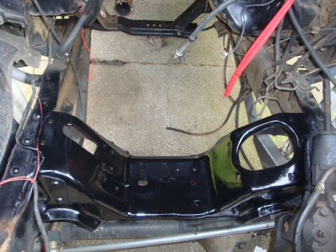 1989 Ford Bronco - Close-up view of a black engine bay frame, likely during a restoration or repair process.