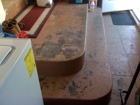 1968 Ford Mustang - Interior view of a laundry area with a washing machine, stairs, and a rug.