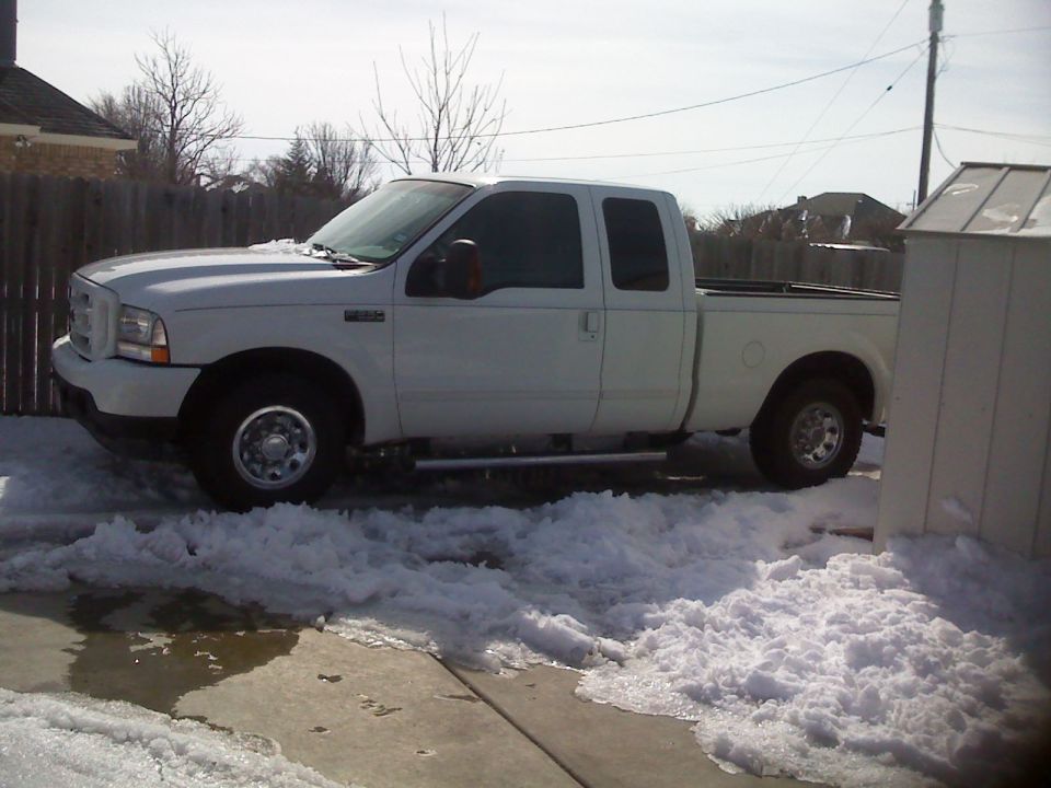 White Ford F-250 pickup truck parked in snow