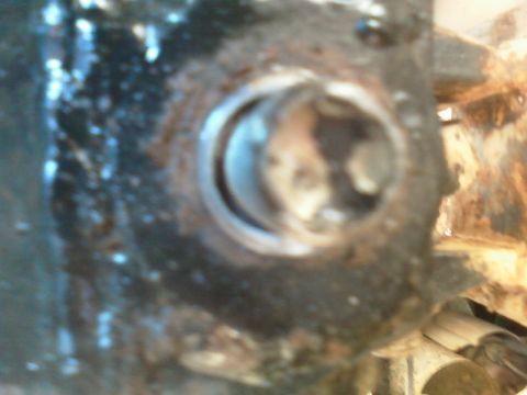 1996 Ford Bronco - This image shows a close-up of a rusty bolt head on a metal component.