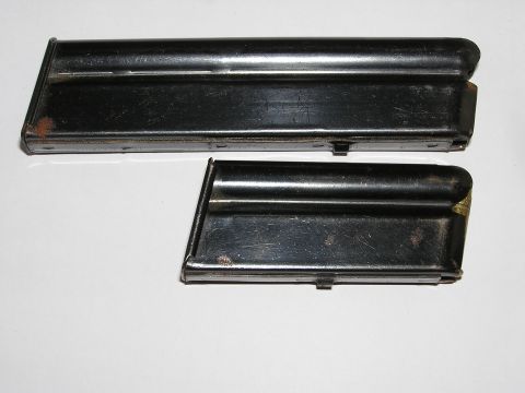 1900 Yugo GVX - Two black metal gun magazines, one longer than the other, show signs of rust.