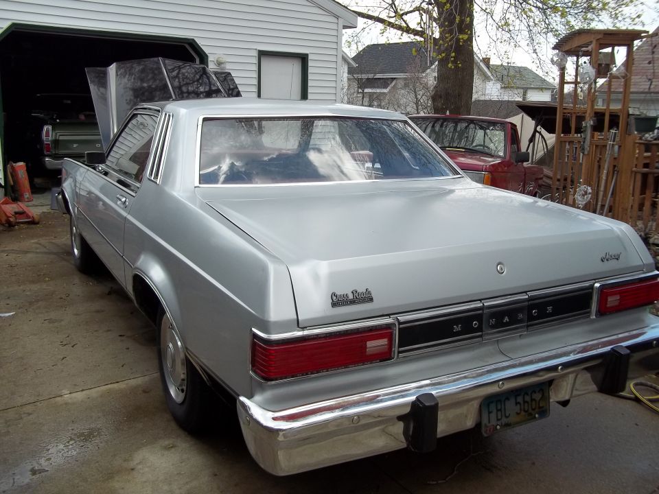 Silver sedan with a Monarch badge, seen from the rear