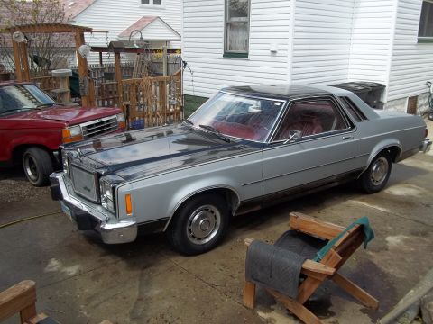 1970 Ford Ranchero - This 1977 Mercury Cougar XR-7 coupe utility features a two-tone silver and black paint scheme with a red interior.