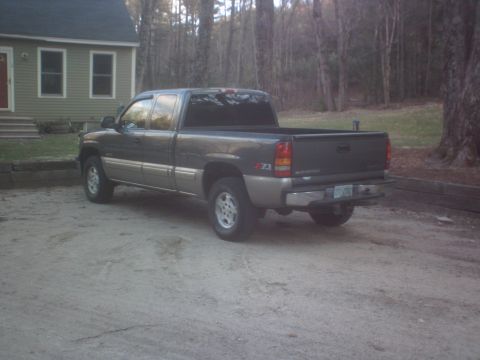 2002 Chevrolet C/K Pickup - This 2002 Chevrolet C/K Pickup truck is shown from the rear three-quarter angle, parked in a gravel driveway.