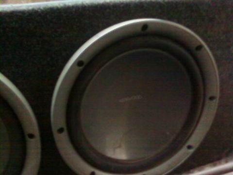 1995 Ford Bronco - A close-up view of a car subwoofer speaker mounted in a box, with visible branding text.