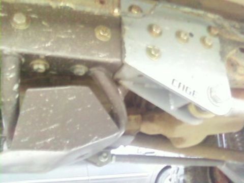 1995 Ford Bronco - A close-up view of a custom 'CAGE' component attached to the undercarriage of a vehicle.