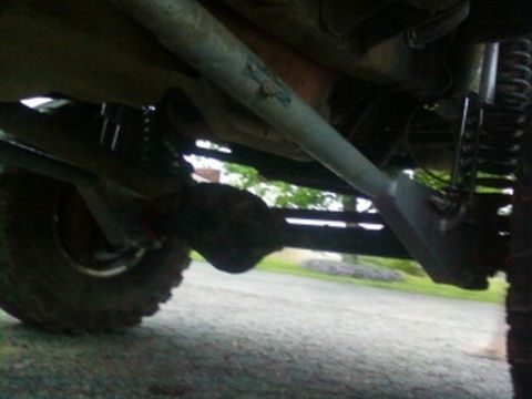 1995 Ford Bronco - An underside view of a vehicle's mechanical components, including suspension and a tire.