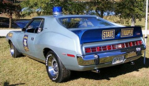 1991 Ford LTD Crown Victoria - This vintage AMC Matador police car is equipped with a light bar and distinctive 'STATE TROOPER' markings.