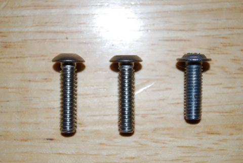 1991 Ford Festiva - Three screws are shown on a wooden background, with varying head designs.