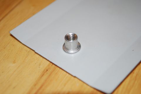1991 Ford Festiva - A rivet nut is shown installed on a panel, likely for attaching accessories.