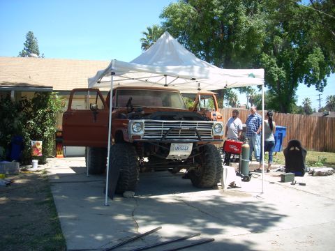 1992 Ford Ranger - This lifted Ford truck appears to be undergoing some work, with its hood open and people gathered around.
