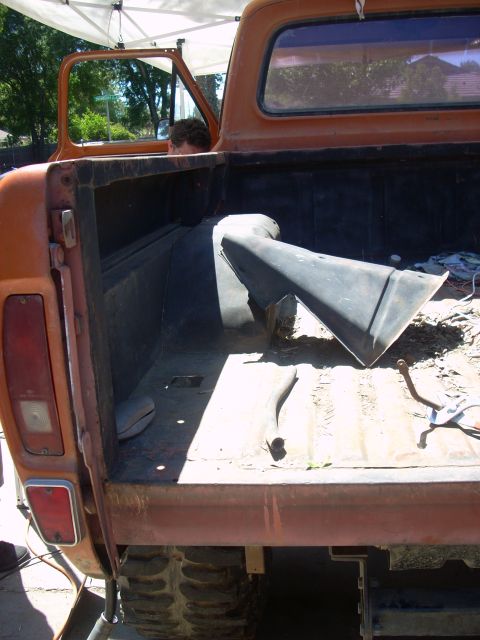 1992 Ford Ranger - The interior of an old orange pickup truck bed is shown, with a person visible through the open door.