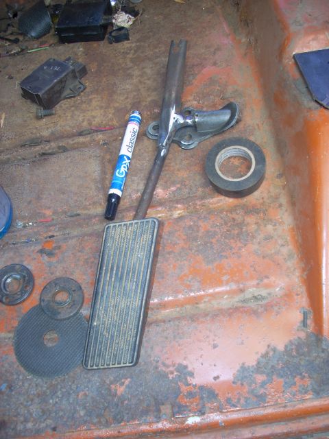 1992 Ford Ranger - The interior floor shows an accelerator pedal assembly, a marker, and tape, with significant rust.
