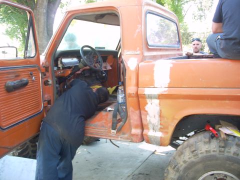 1992 Ford Ranger - Repair work underway inside the cab of an orange pickup truck.