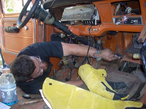 1992 Ford Ranger - A person is working on the complex wiring system of a vehicle's dashboard.