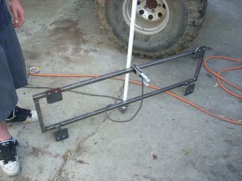 1992 Ford Ranger - A custom metal fabrication part is shown, likely for a vehicle, with mounting brackets and a clamp attached.