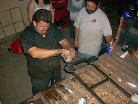 1992 Ford Ranger - People are working on a metal frame in what appears to be a garage or workshop.