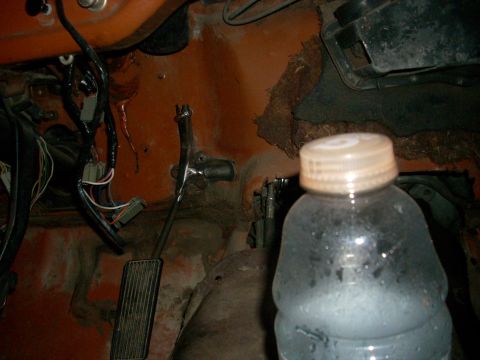 1992 Ford Ranger - The image shows the driver's side footwell of a vehicle, with visible rust and exposed wiring.