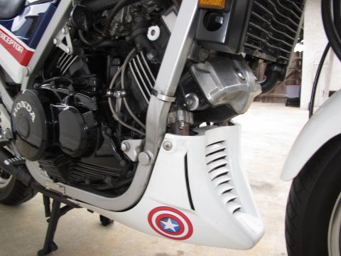 1984 Honda Interceptor - Close-up view of a motorcycle's engine and lower fairing, a Captain America shield emblem.