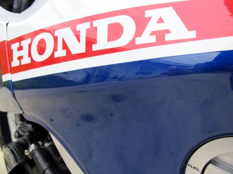 1984 Honda Interceptor - The side panel of a motorcycle displays the HONDA logo with red and white stripes over a blue base.