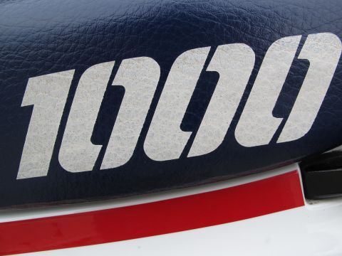 1984 Honda Interceptor - The emblem '1000' is visible on the blue seat of a motorcycle, accented by a red stripe.