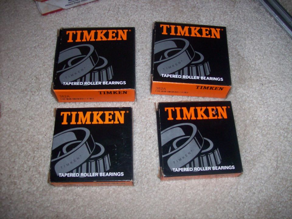 Four boxes of Timken tapered roller bearings on a carpeted surface