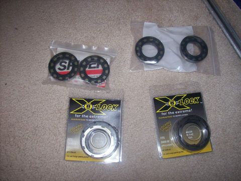 1982 Ford F-100 - Several packages of X-Lock locking spindle nuts and bearings are laid out on a carpeted surface.