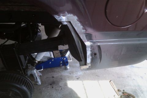 1994 Chevrolet Blazer - The underside of a vehicle is shown with suspension components and bodywork in progress.