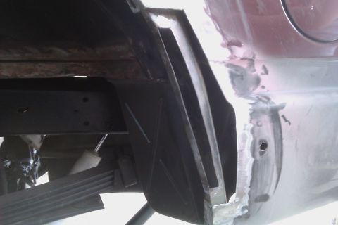 1994 Chevrolet Blazer - Close-up view of a vehicle's undercarriage, highlighting areas of rust and recent repairs on the body.