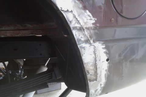 1994 Chevrolet Blazer - This photo shows the underside of a vehicle, focusing on the wheel well and suspension components, indicating repair work.