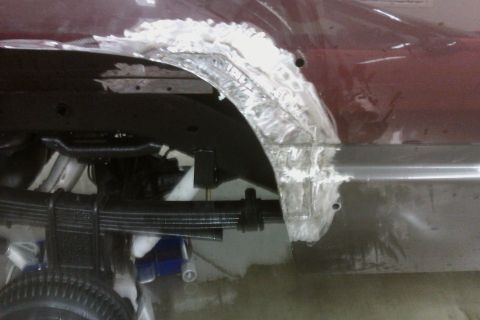 1994 Chevrolet Blazer - Body work in progress on a vehicle's rear wheel well, showing rust repair.
