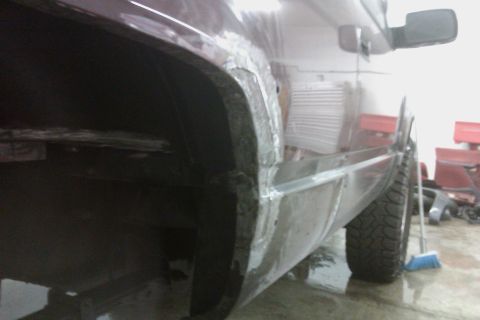 1994 Chevrolet Blazer - Bodywork is underway on the rear wheel well and rocker panel of a vehicle.