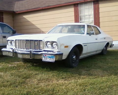 1976 Ford Torino - This 1976 Ford Torino is seen from a 3/4 front angle, a prominent chrome grille and Texas license plate.