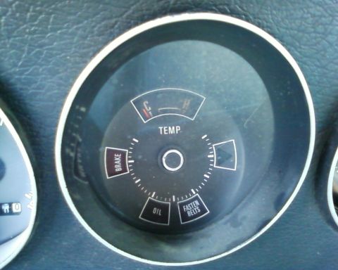 1976 Ford Torino - Close-up of a vehicle's interior dashboard, showing various gauges and warning lights.