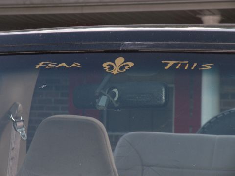 1996 Ford Bronco - The interior of a vehicle is visible, a "FEAR THIS" decal on the windshield above the rearview mirror.