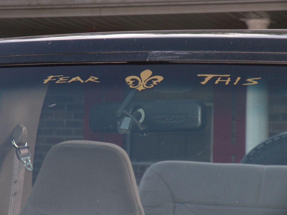 Interior view of a vehicle with "FEAR THIS" decal on the windshield
