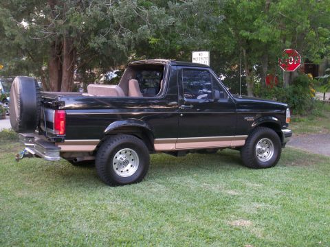 1996 Ford Bronco - This black 1996 Ford Bronco features tan trim and a spare tire mounted on the rear.