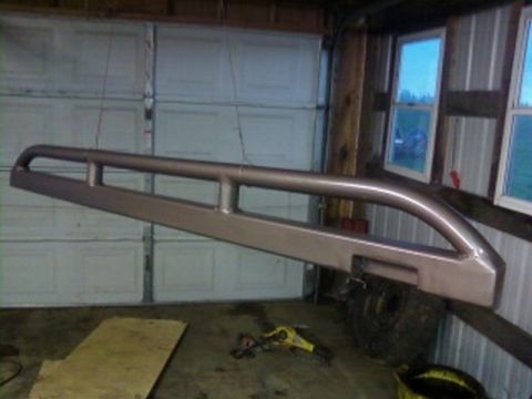 1995 Ford Bronco - Rock sliders are shown hanging in a garage, ready for installation.