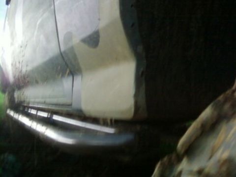 1995 Ford Bronco - This vehicle features chrome rock sliders and a camouflage paint scheme, with the lower body visible.