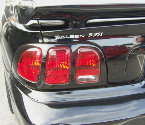 2007 Ford Mustang - Rear view of a black car with distinctive triple taillights and Saleen S351 badging.