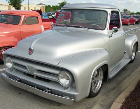2007 Ford Mustang - A classic silver pickup truck is parked in a lot, with another vintage truck beside it.