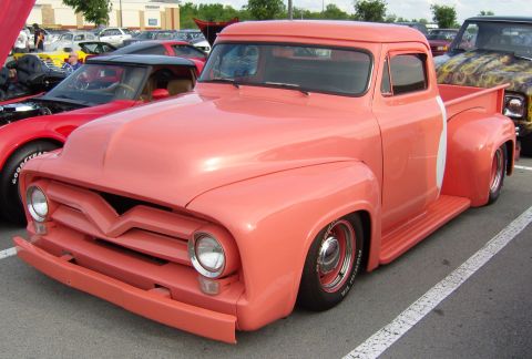 2007 Ford Mustang - A classic salmon-colored Ford F-Series truck is parked at an outdoor event.