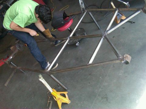 1995 Ford F-150 - Custom metal frame being welded in a workshop environment.