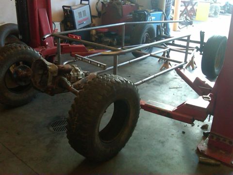 1995 Ford F-150 - A custom tube chassis, likely for a buggy project, is shown on jack stands in a workshop setting.