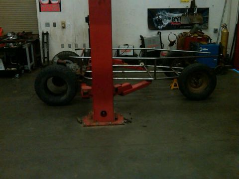 1995 Ford F-150 - A custom-built vehicle chassis is shown on a lift in a workshop environment.