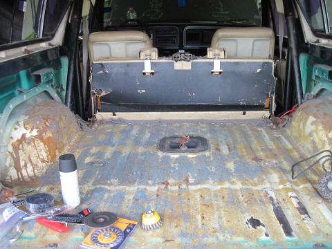 1979 Ford Bronco - The interior of a 1978 Ford Bronco shows significant wear and rust in the cargo area.