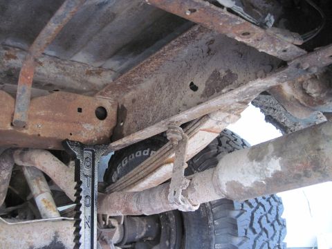 1979 Ford Bronco - The underside of a 1979 Ford Bronco reveals significant rust on its frame and suspension components.