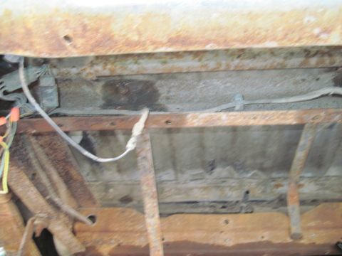 1979 Ford Bronco - The underside of the vehicle shows significant rust and exposed wiring, indicating potential maintenance needs.