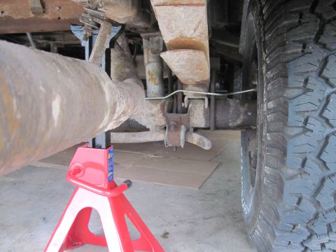 1979 Ford Bronco - Undercarriage view of a vehicle's rear axle and exhaust system, supported by jack stands.